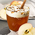 Hot chai apple cider topped with whipped cream and cinnamon